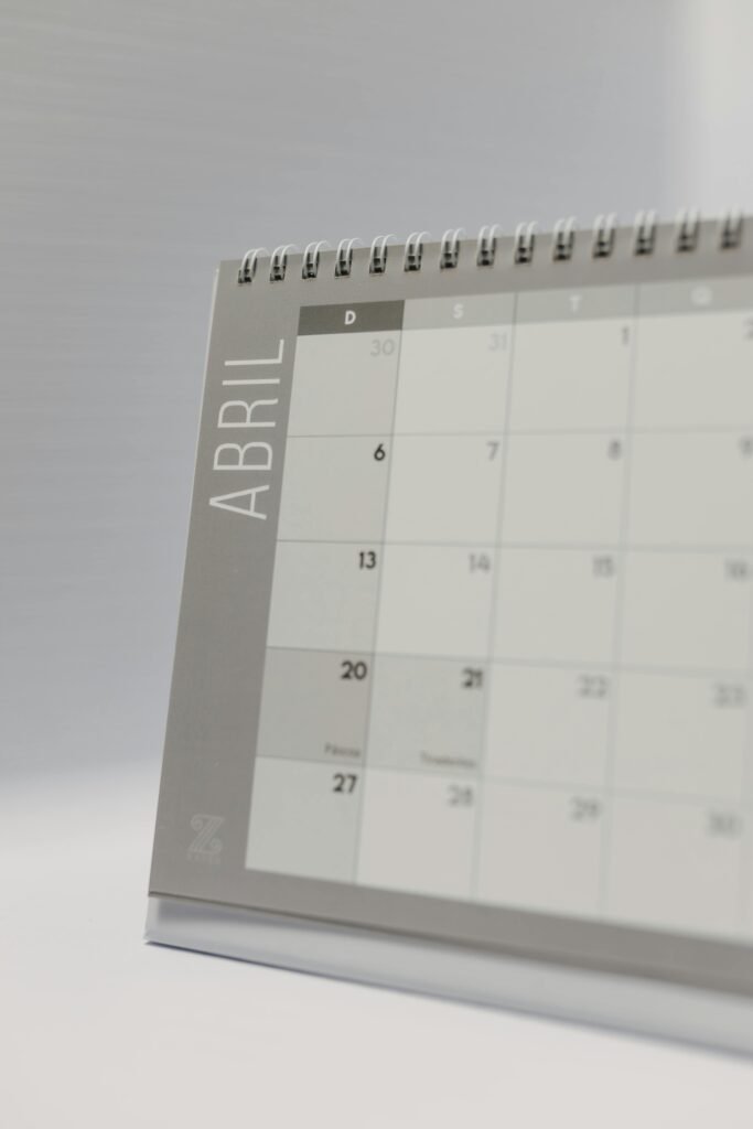 Close-up image of a minimalist desk calendar displaying April dates with a neutral background.